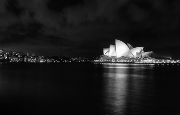 An illuminated Sydney Opera House from Circular Quay.