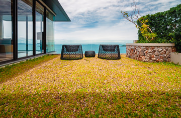 Ocean view pool villa front lawn.