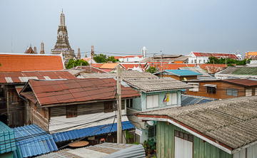 Bangkok rooftops with Wat Arun in the distance.