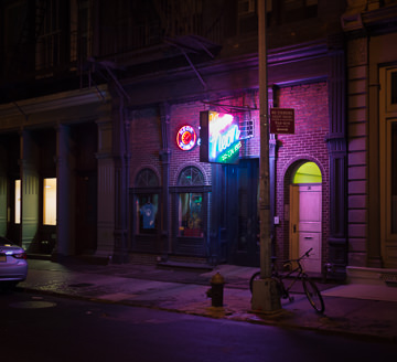 Let There Be Neon sign shop glows at night.