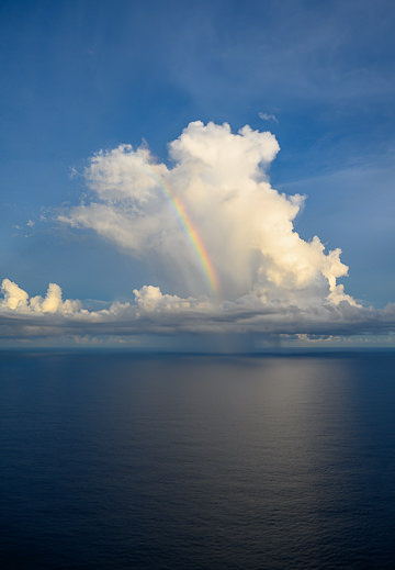 Rainbow in a storm cloud over the Indian Ocean.