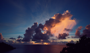 Pastel-colored clouds at sunset over Anse La Liberte, Seychelles.